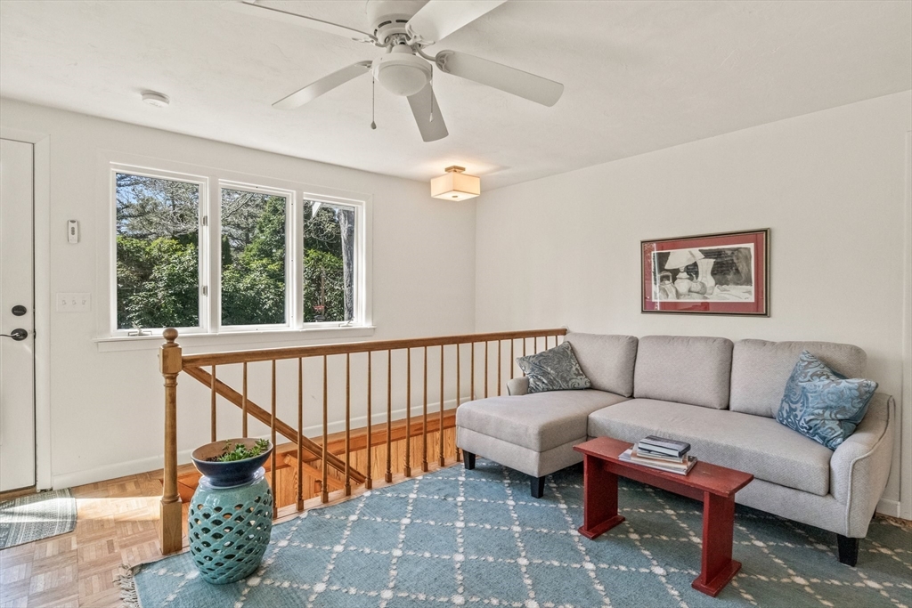 81 Crawford Road Barnstable, MA 02635 - Photo 20 of 42 a living room with furniture a rug and a chandelier
