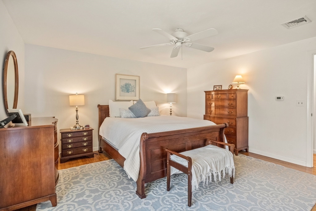 81 Crawford Road Barnstable, MA 02635 - Photo 26 of 42 a bedroom with a bed and dresser with mirror