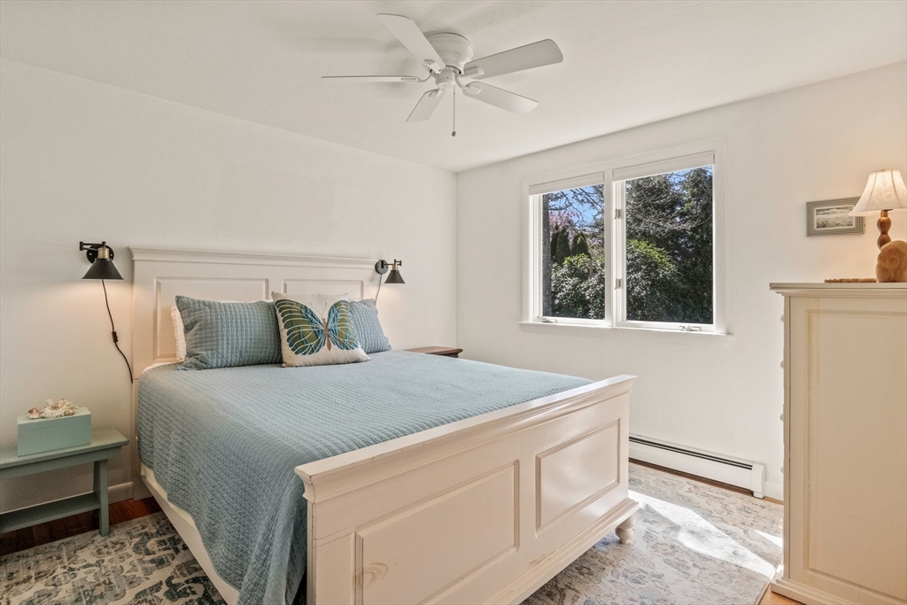 81 Crawford Road Barnstable, MA 02635 - Photo 27 of 42 a bedroom with a bed and a chandelier