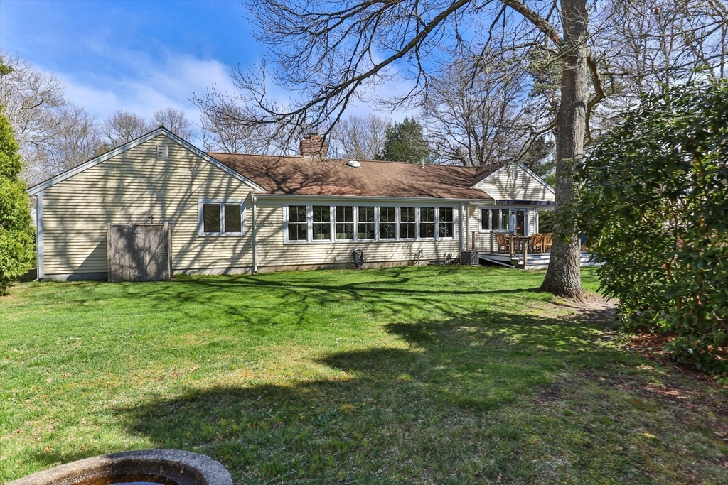 81 Crawford Road Barnstable, MA 02635 - Photo 35 of 42 a view of a house with a yard and sitting area