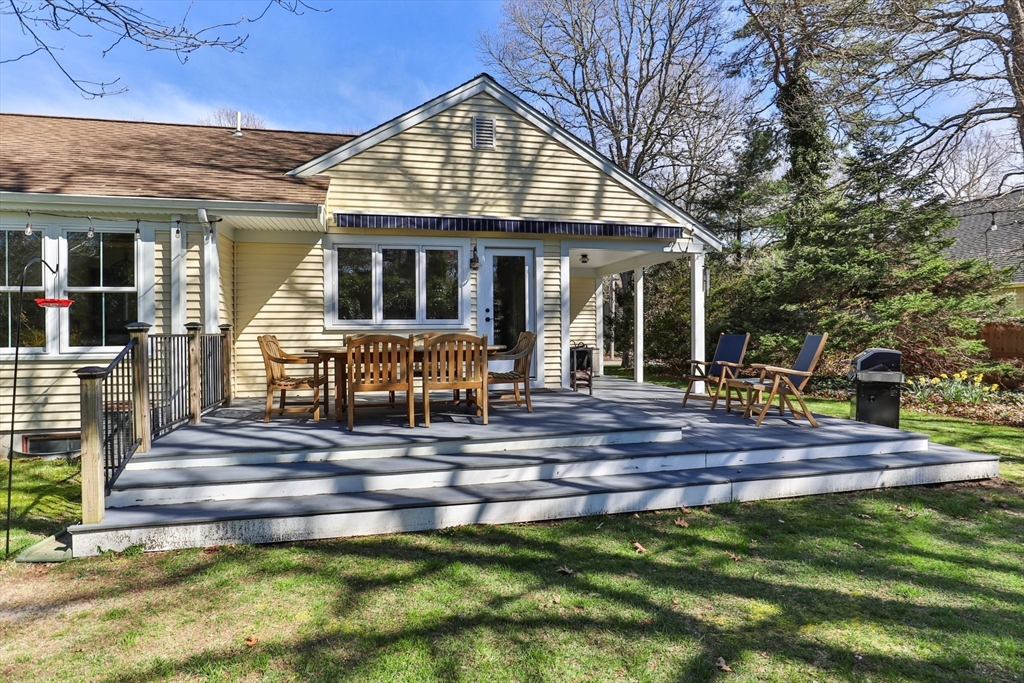 81 Crawford Road Barnstable, MA 02635 - Photo 37 of 42 a view of a house with a yard patio and fire pit