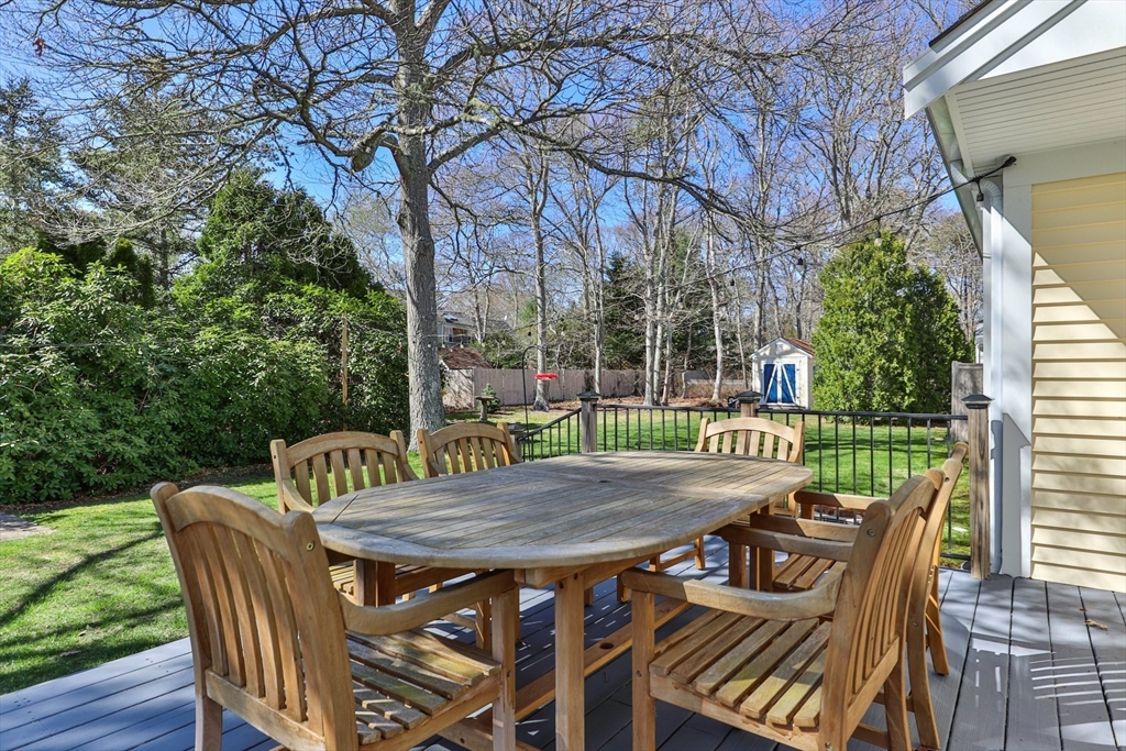 81 Crawford Road Barnstable, MA 02635 - Photo 39 of 42 a view of a patio with a table chairs and a deck
