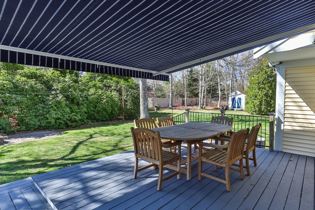 81 Crawford Road Barnstable, MA 02635 - Photo 41 of 42 a patio with wooden floor a yard a table and chairs