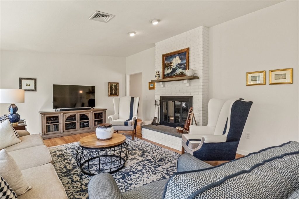 81 Crawford Road Barnstable, MA 02635 - Photo 8 of 42 a living room with furniture a flat screen tv and a fireplace
