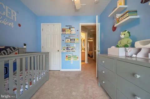 a bedroom with furniture and a baby crib