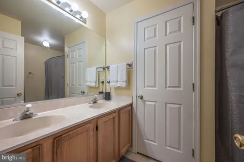 a bathroom with double sink and a mirror