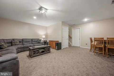 a living room with furniture and a ceiling fan