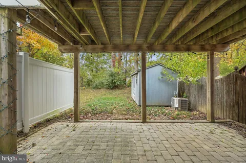 a backyard of a house with garden and outdoor seating