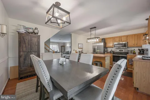 a view of a dining room with furniture and a chandelier