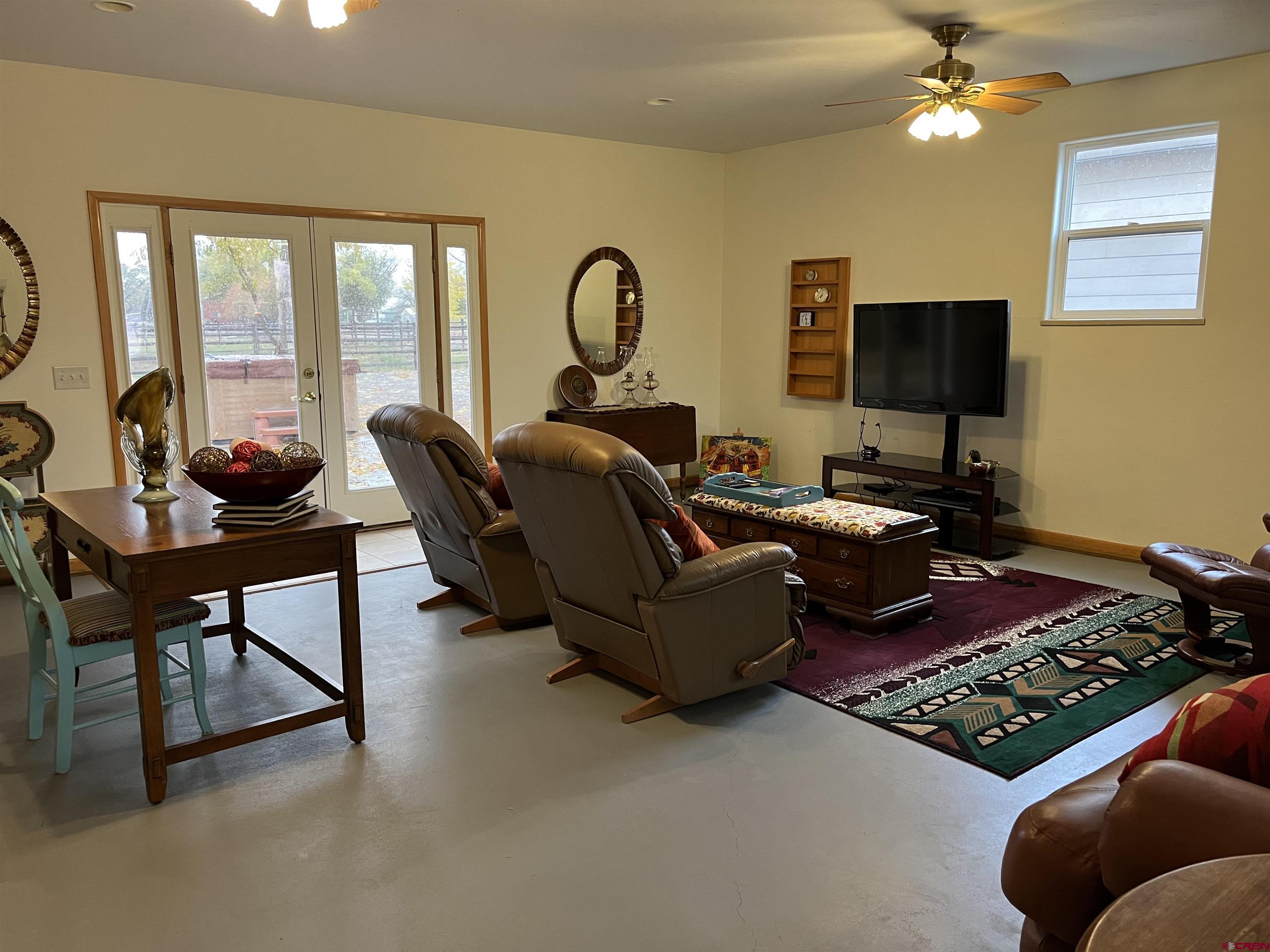 487 1775th Court Delta, CO 81416 - Photo 14 of 35 a living room with furniture and a flat screen tv