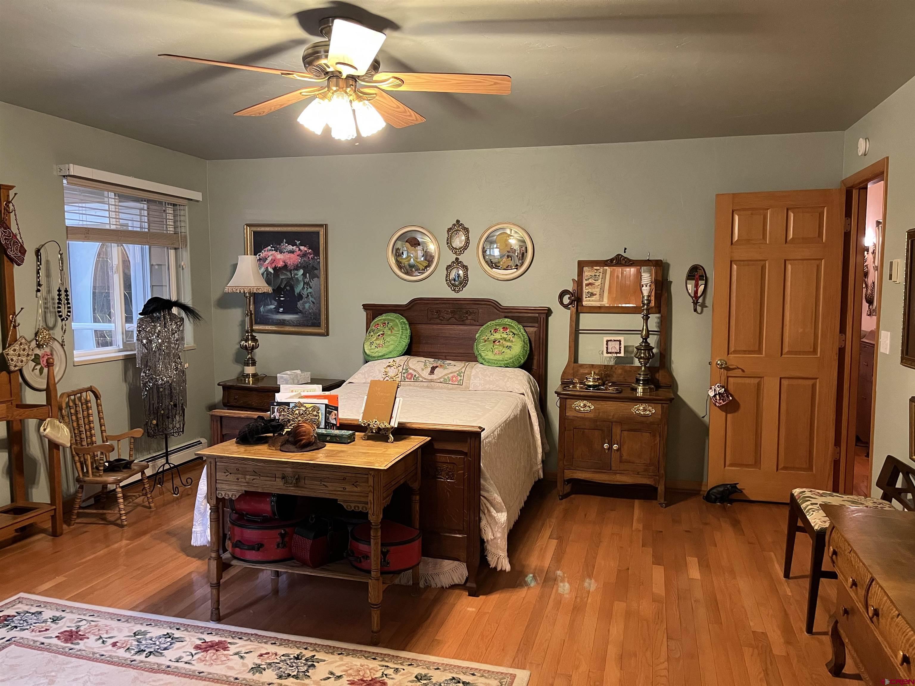 487 1775th Court Delta, CO 81416 - Photo 16 of 35 a bed room with a bed and a chandelier
