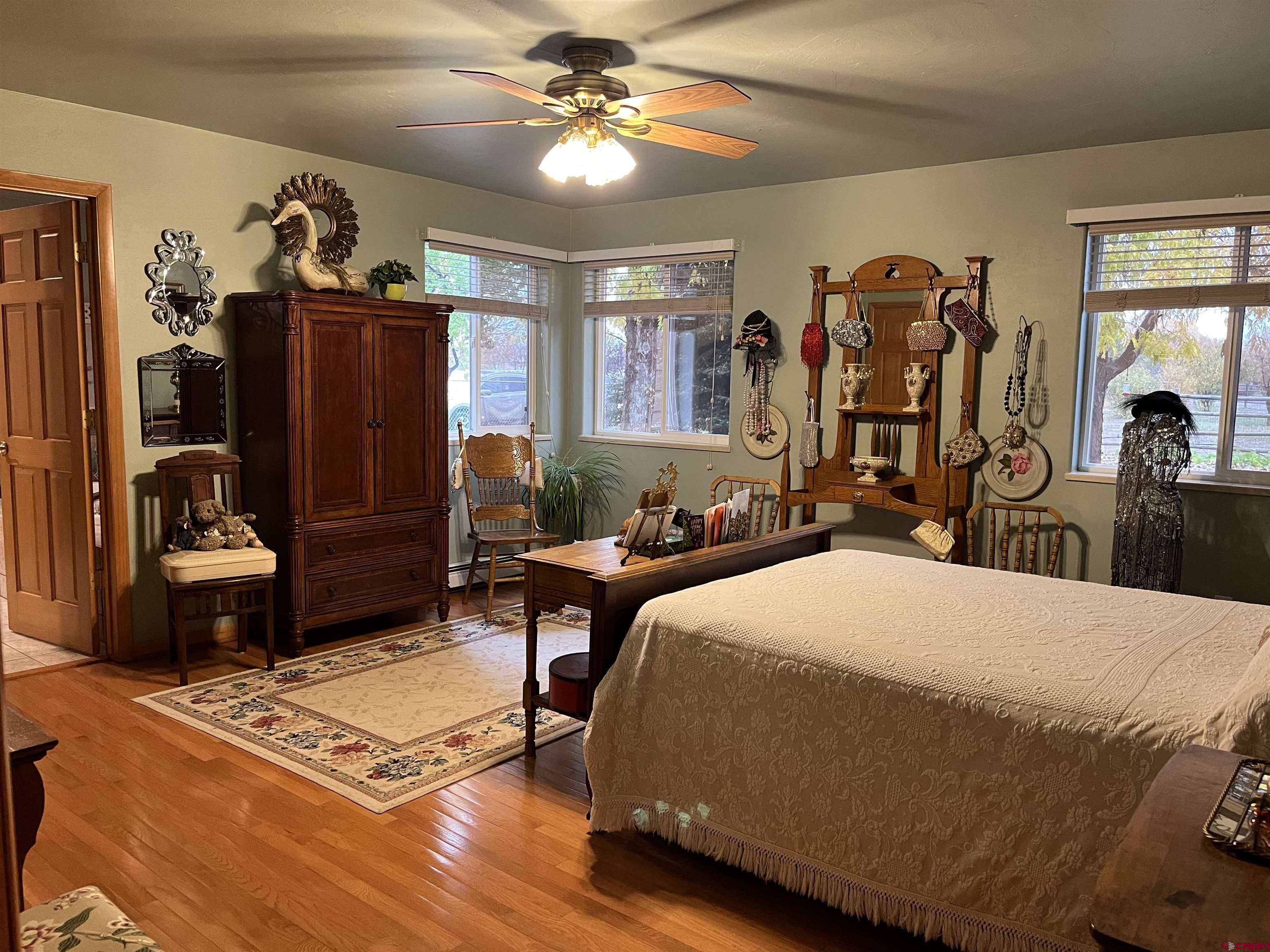 487 1775th Court Delta, CO 81416 - Photo 17 of 35 a bedroom with a bed and wooden floor