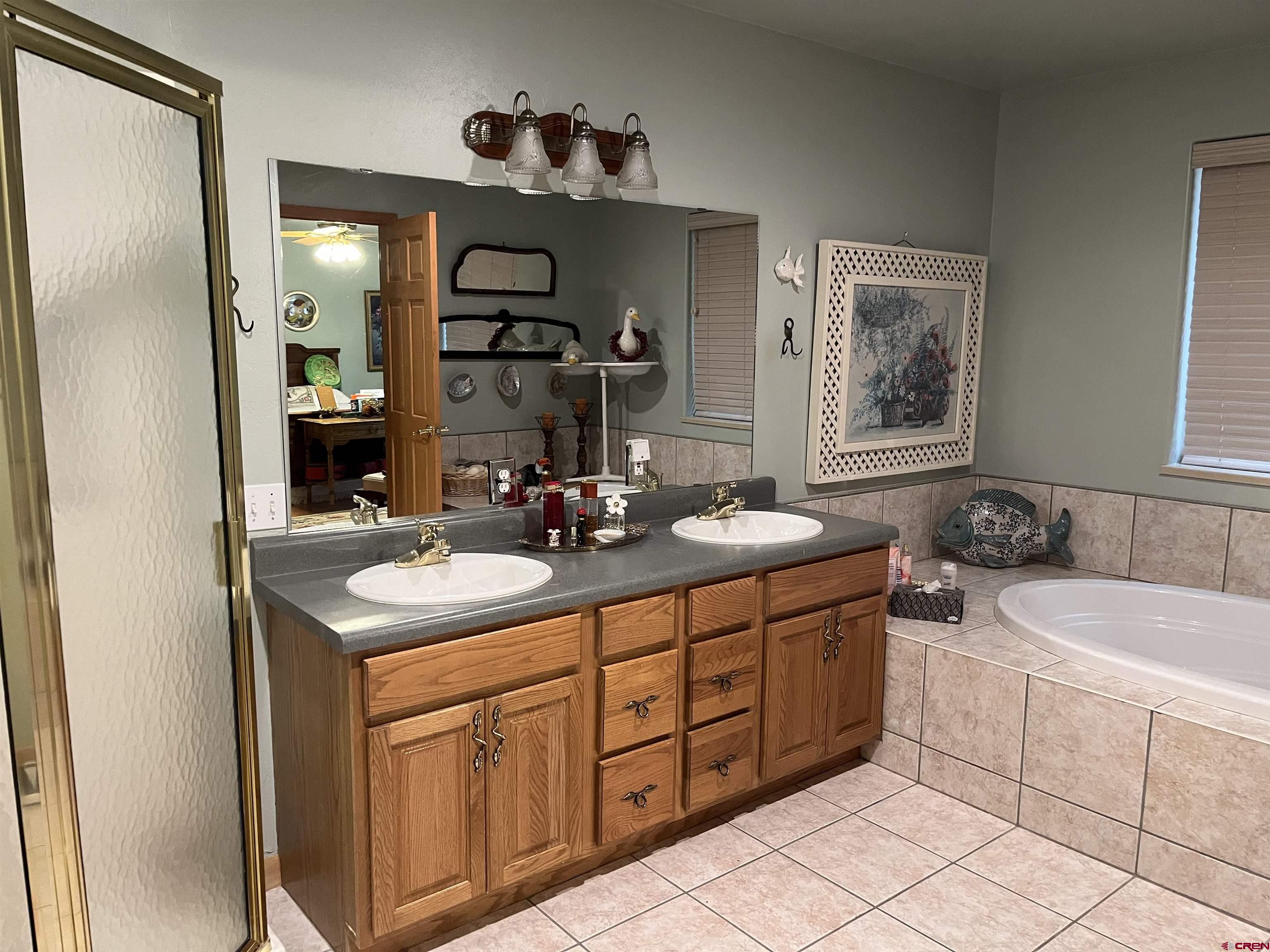 487 1775th Court Delta, CO 81416 - Photo 18 of 35 a bathroom with a double vanity sink and a mirror