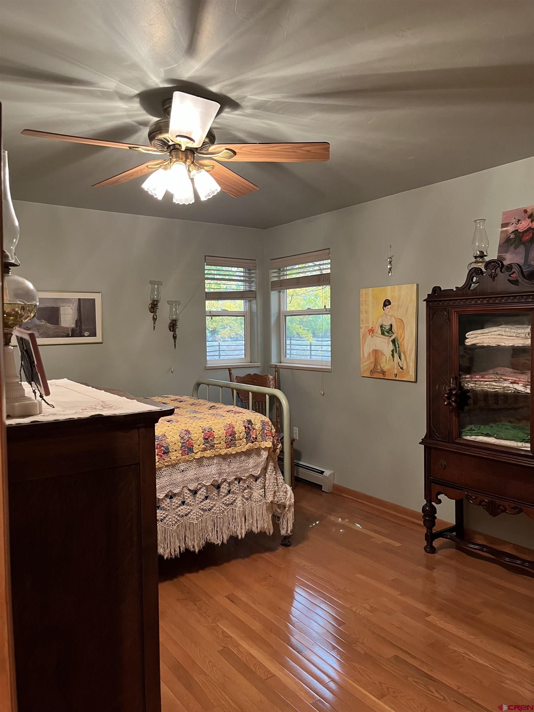 487 1775th Court Delta, CO 81416 - Photo 21 of 35 a bedroom with a bed and a chandelier