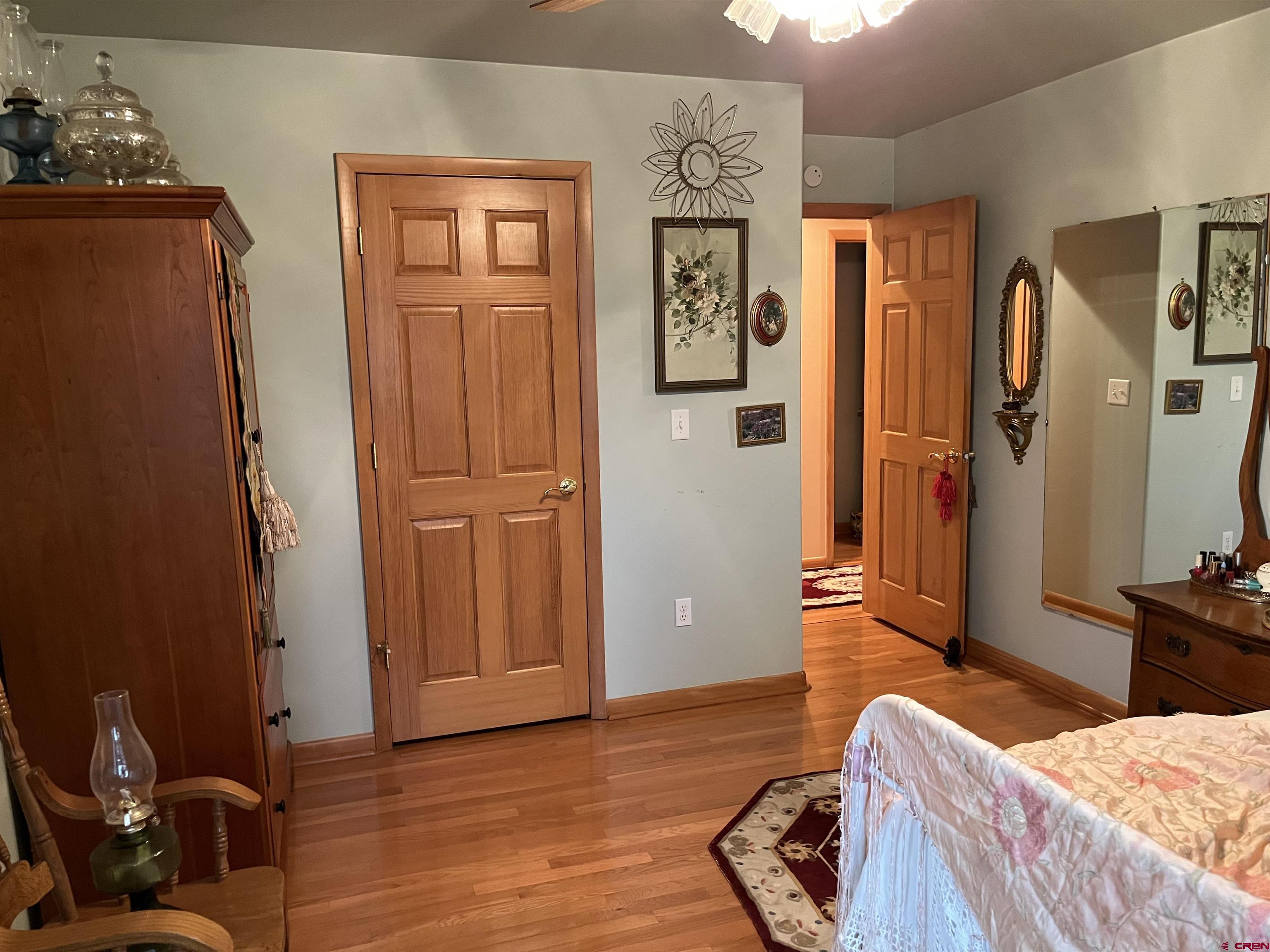 487 1775th Court Delta, CO 81416 - Photo 23 of 35 a bedroom with a bed and wooden floor