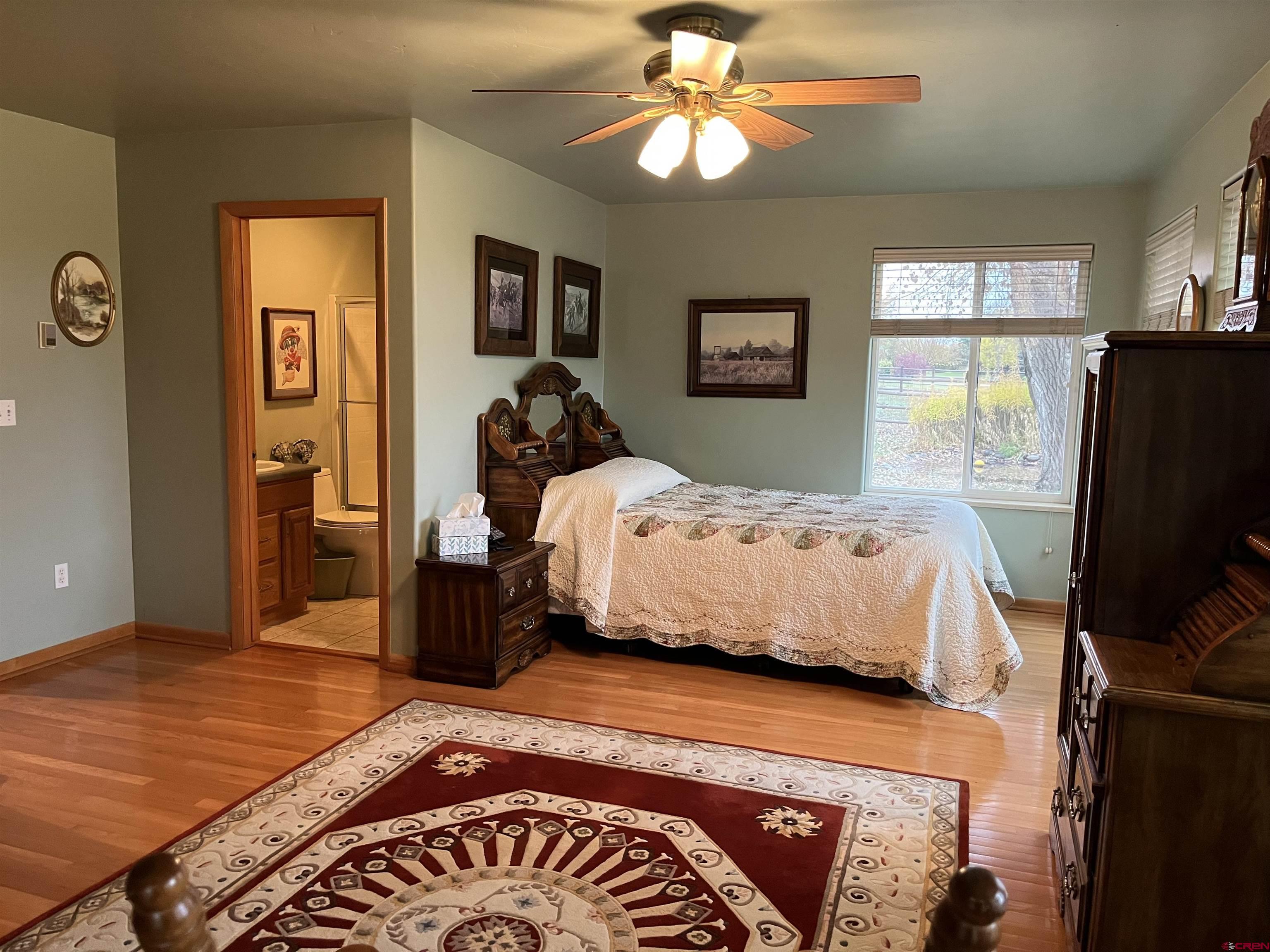 487 1775th Court Delta, CO 81416 - Photo 26 of 35 a bedroom with a bed and wooden floor