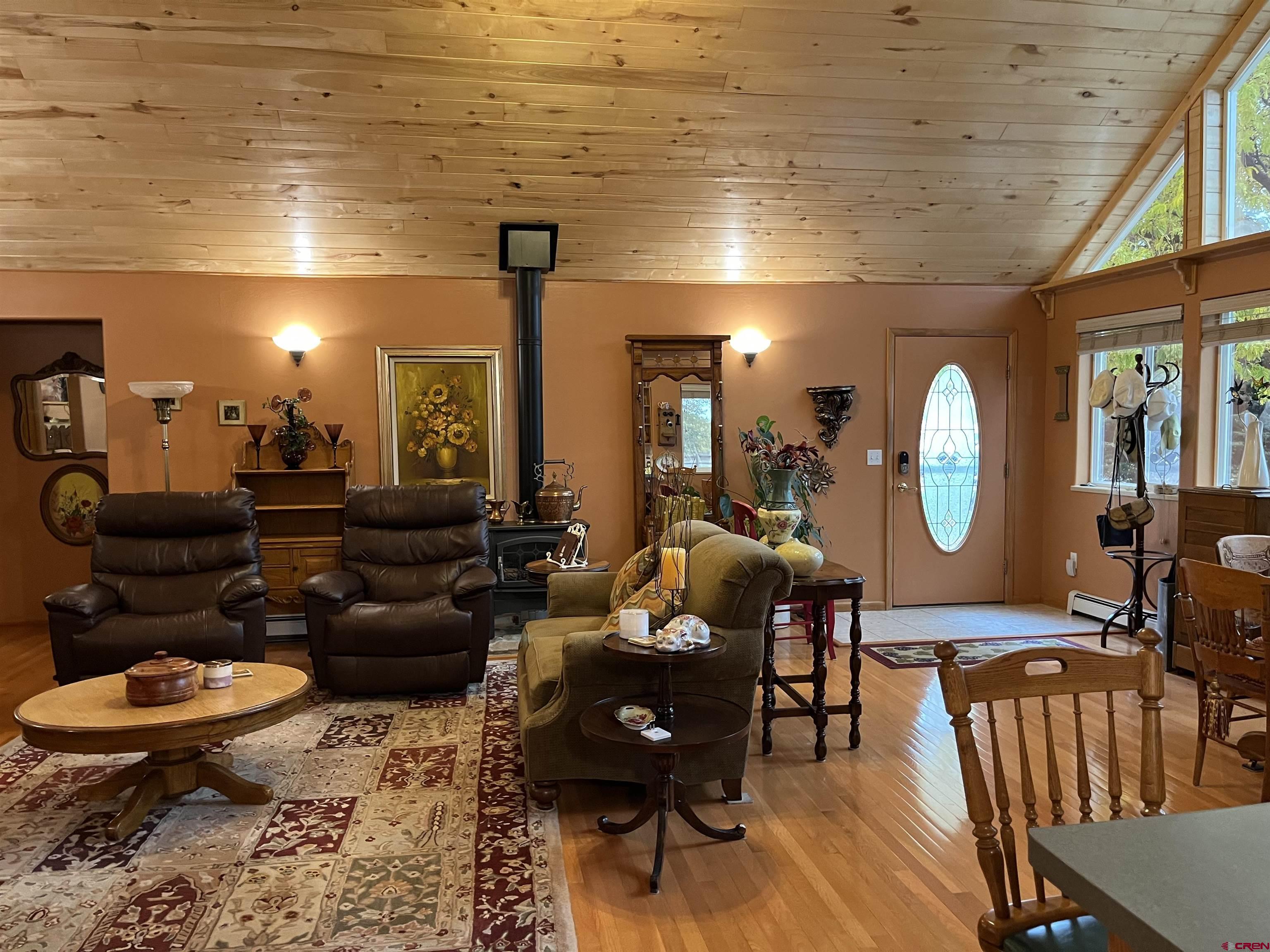 487 1775th Court Delta, CO 81416 - Photo 3 of 35 a living room with furniture a rug and a mirror