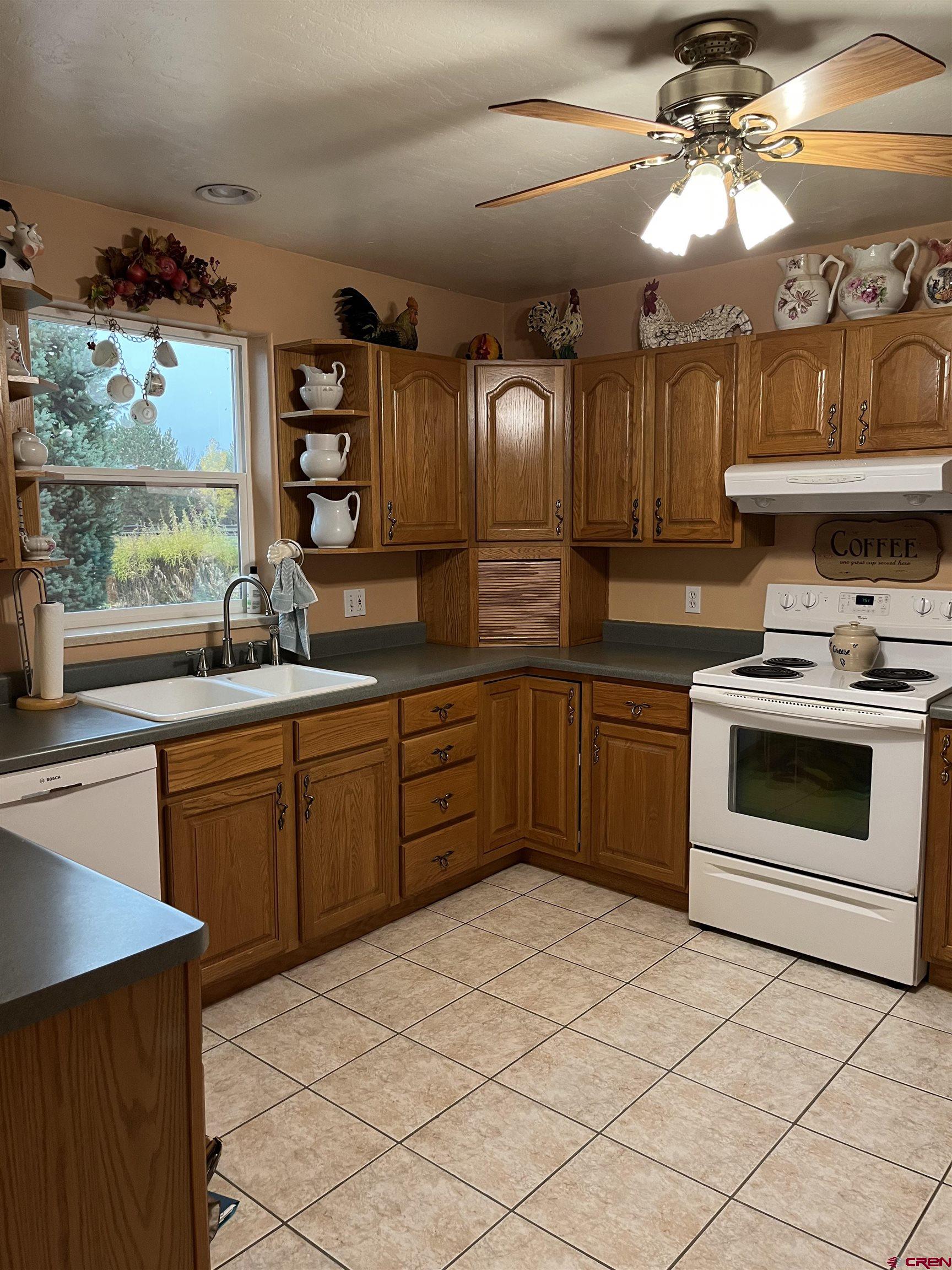 487 1775th Court Delta, CO 81416 - Photo 8 of 35 a kitchen with a sink cabinets and window