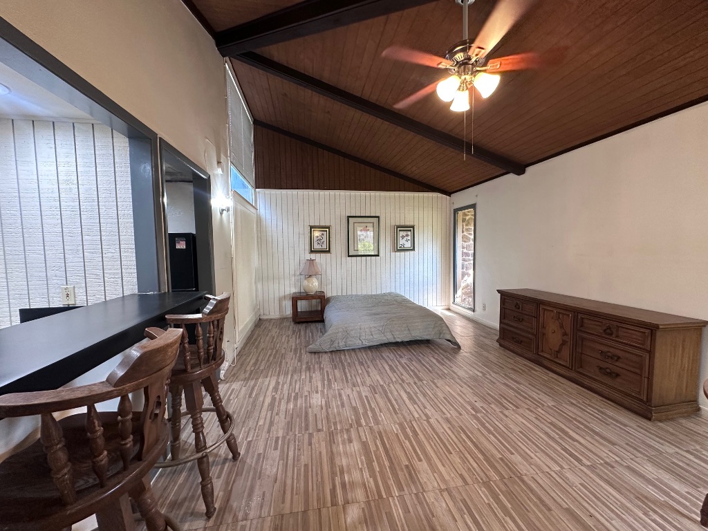 126 Conference Drive, Unit 212 Bastrop, TX 78602 - Photo 4 of 9 a bedroom with furniture and a wooden floor