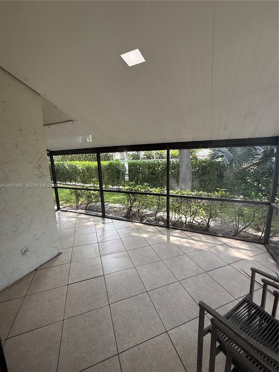 7200 Northwest 2nd Avenue, Unit 160 Boca Raton, FL 33487 - Photo 31 of 40 a view of an empty room with a floor to ceiling window and an outdoor view