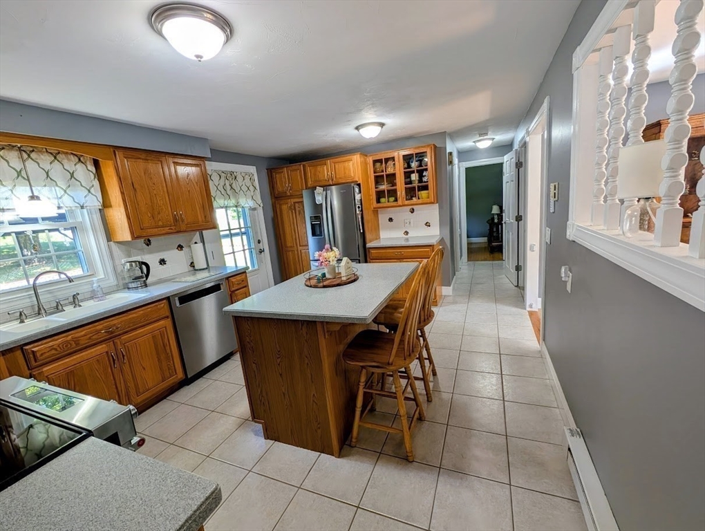 10 Harrington Road Charlton, MA 01507 - Photo 23 of 36 a dining hall with stainless steel appliances a table and chairs