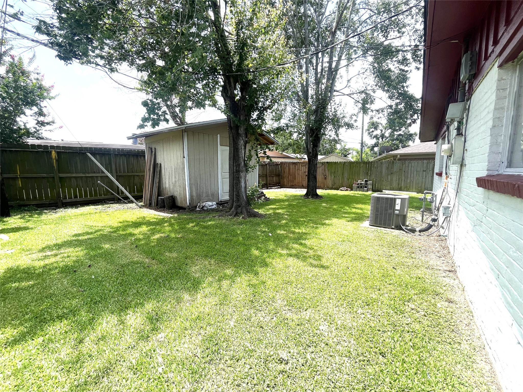 12332 Kayla Lane Houston, TX 77015 - Photo 14 of 15 a view of a backyard with large trees and a large tree
