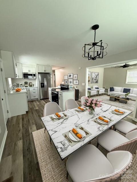 436 Clinton Avenue Lancaster, SC 29720 - Photo 5 of 11 a open dining room with stainless steel appliances kitchen island granite countertop a table chairs and a wooden floor