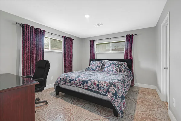 a bedroom with a bed and a tv