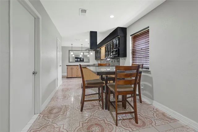 a kitchen with stainless steel appliances granite countertop a sink a stove and a refrigerator