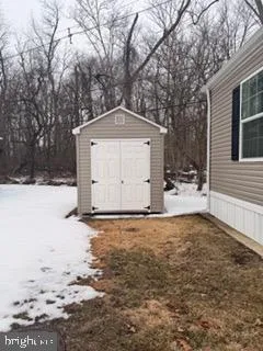 a house with a yard covered with snow in front of house