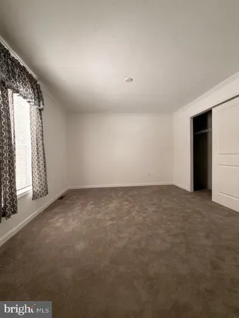 an empty room with a empty space and windows