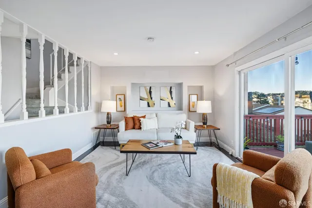 a kitchen with stainless steel appliances wooden floor and dining table