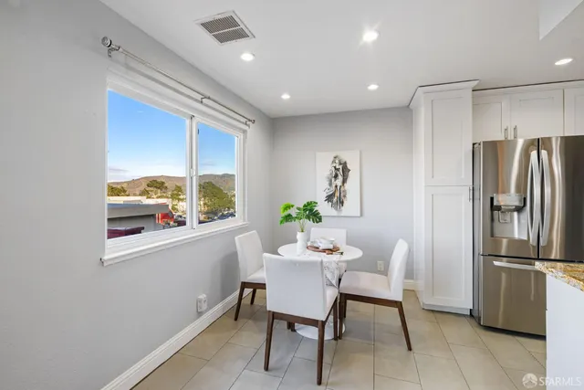 a dining room with furniture a rug and wooden floor