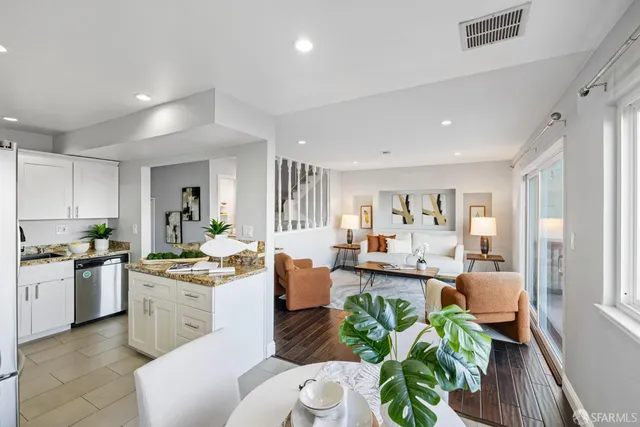 a kitchen with a refrigerator and a dining table