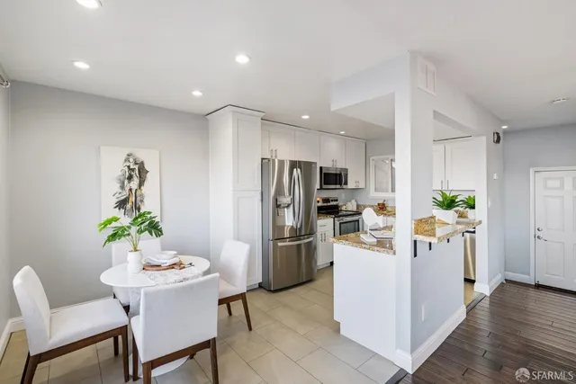 a kitchen with granite countertop a sink a stove and cabinets