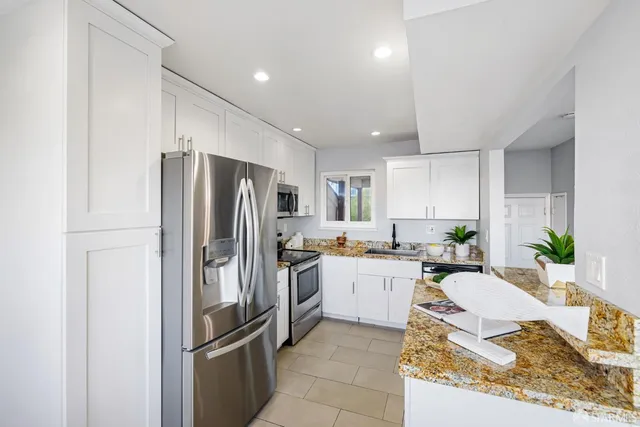 a kitchen with a table chairs and a refrigerator