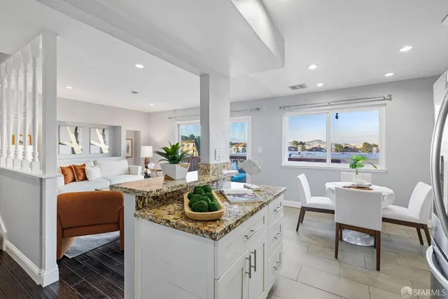 a kitchen with refrigerator a microwave and stove