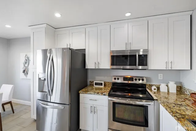 a kitchen with a stove and cabinets