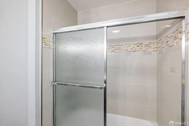 a bathroom with a sink a toilet and a shower