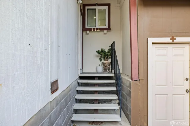 a view of entryway with wooden floor and stairs