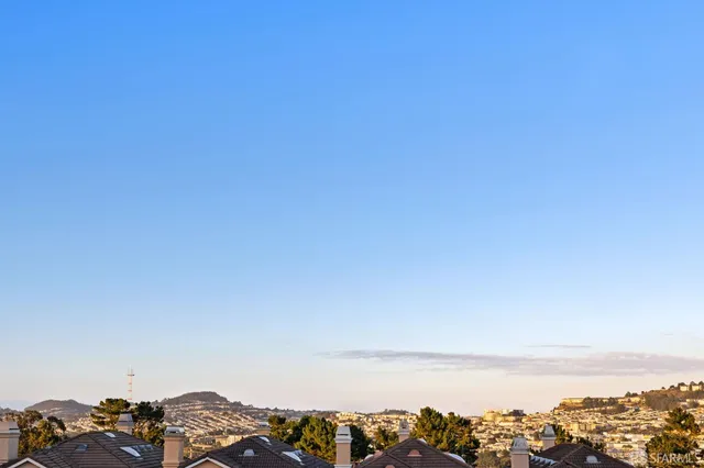 an aerial view of multiple houses with a yard