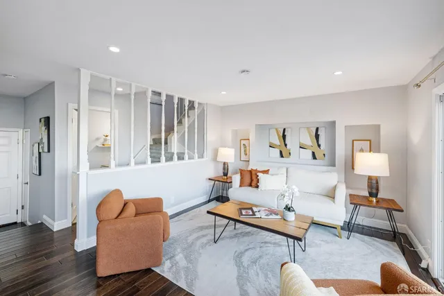a living room with furniture a rug and a large window