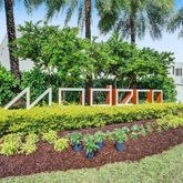 a front view of a house with a yard and potted plants