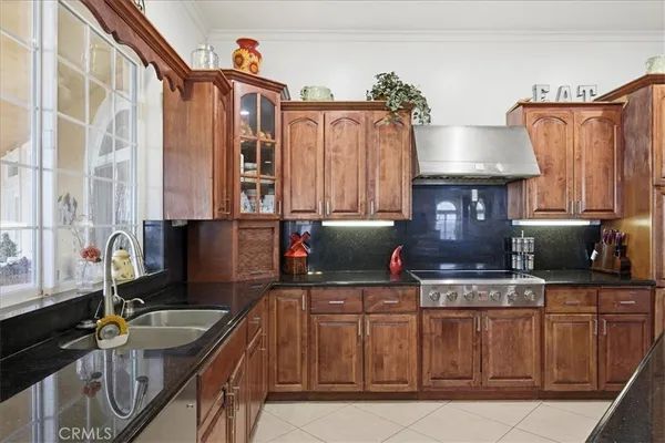 a kitchen with stainless steel appliances a sink stove and refrigerator