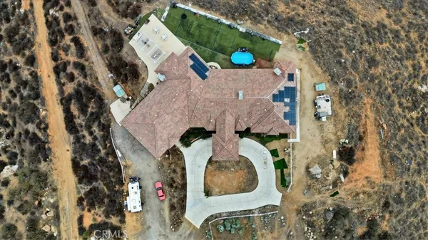 an aerial view of a house with outdoor space and sitting area