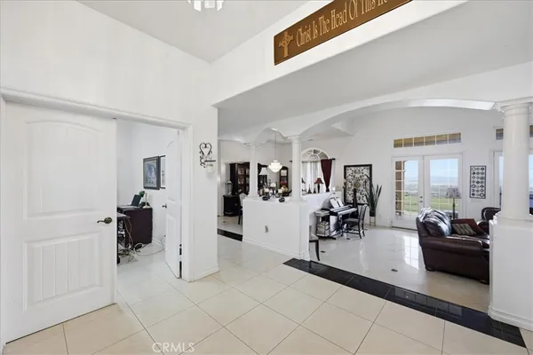 a bedroom with a bed flat screen tv and a chandelier