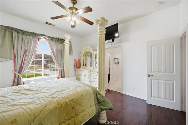 a bed room with a bed and wooden floor