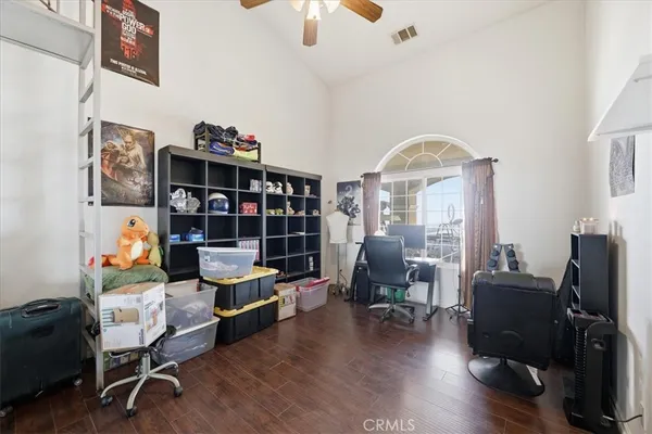 a living room with lots of furniture and view of kitchen