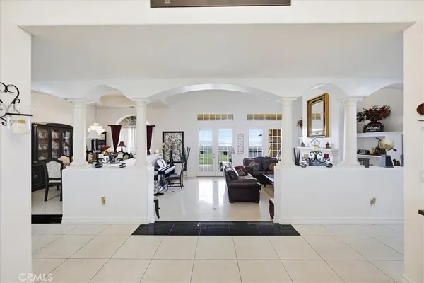 a living room with furniture and large mirror
