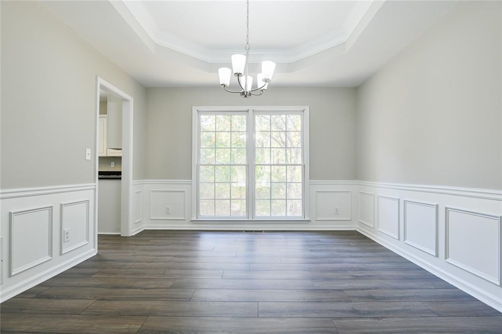2670 Factor Walk Boulevard Suwanee, GA 30024 - Photo 16 of 57 a view of an empty room with wooden floor and a window
